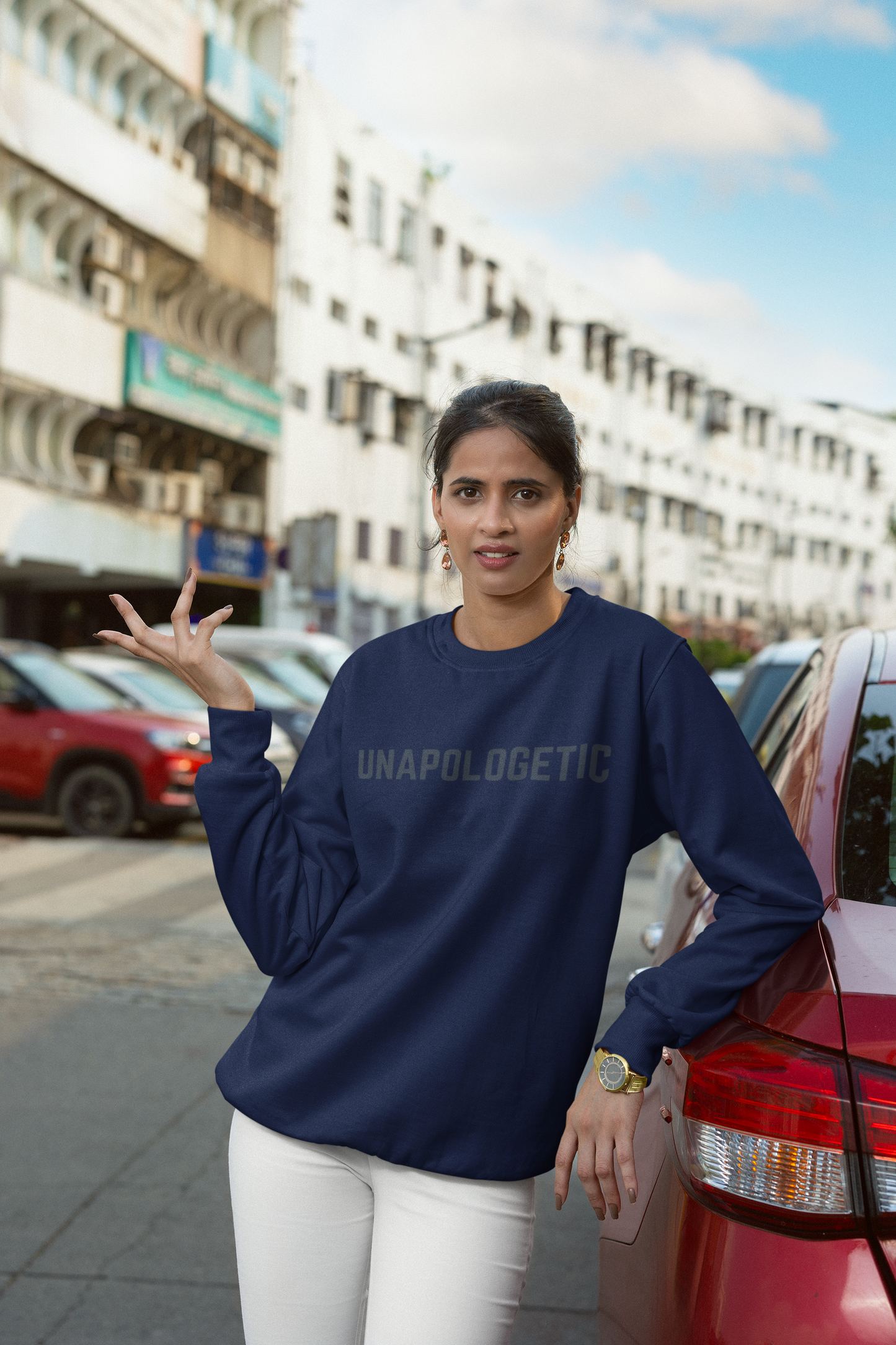 Indian woman wearing a Navy blue sweatshirt with Unapologetic written on it