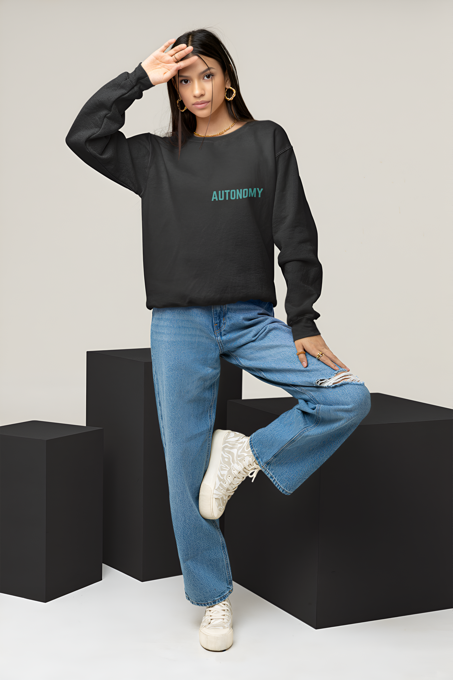 A female wearing a best quality sweatshirt of Black color with Autonomy written over it