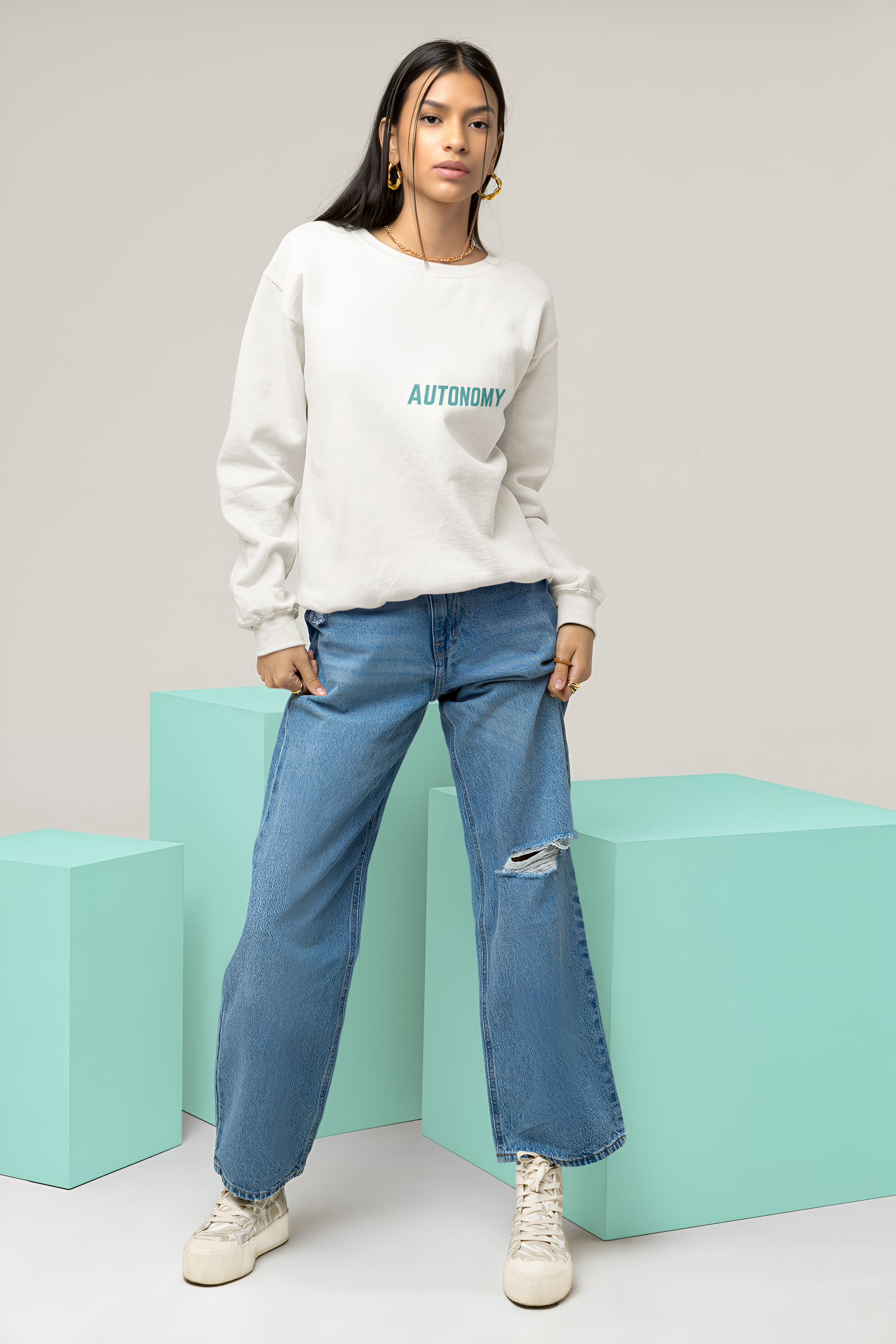 A female wearing a best quality sweatshirt of White color with Autonomy written over it