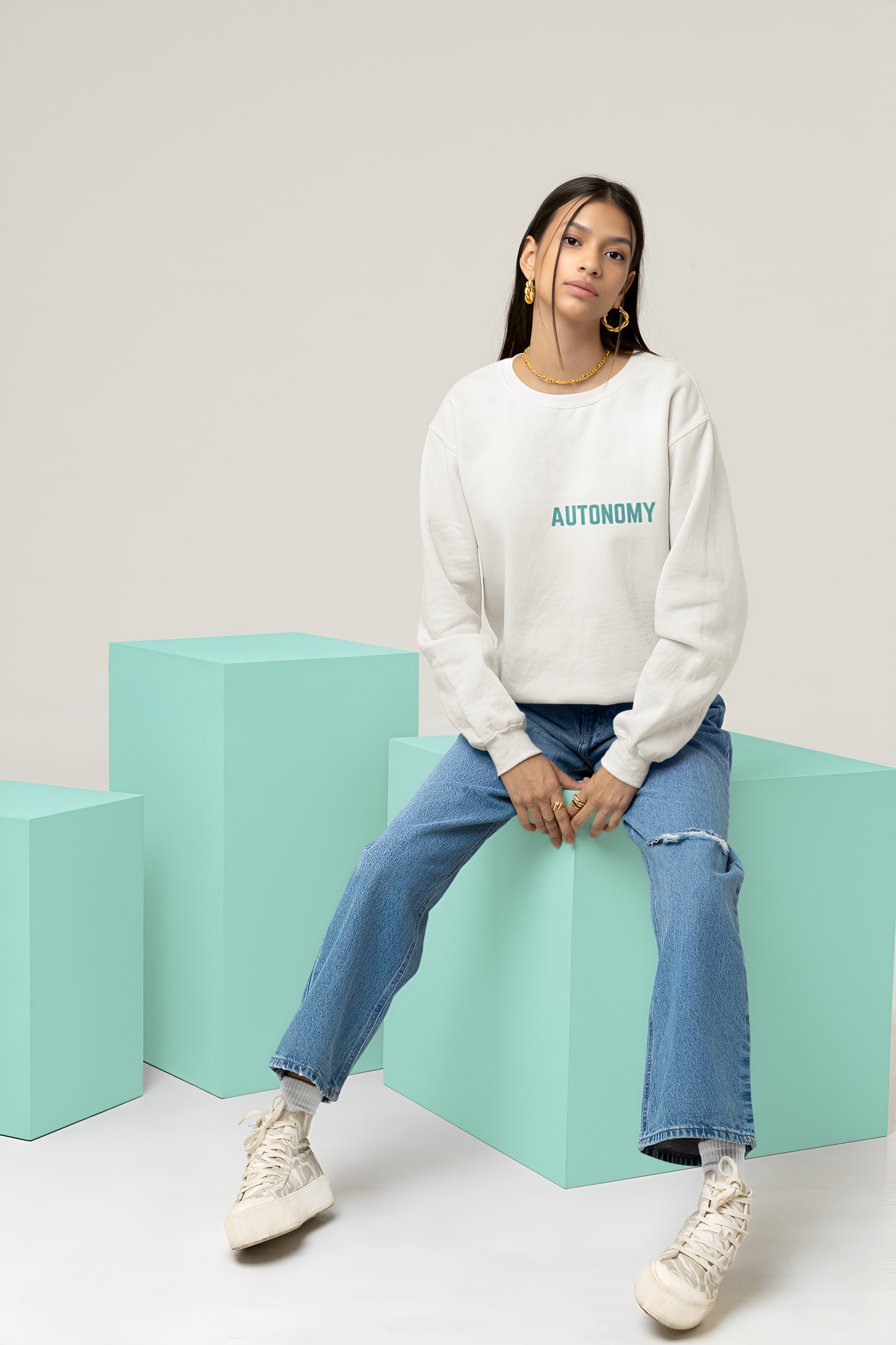 A female wearing a best quality sweatshirt of White color with Autonomy written over it